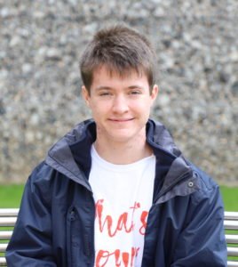 boy sitting on a bench smiling