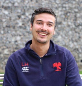 man sitting on a bench smiling