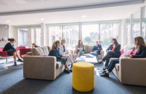 Girls sitting on sofas in a boarding house